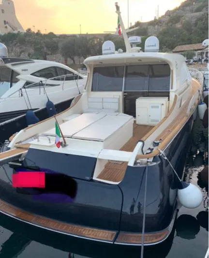  Yacht Photos Pics 2005 Mochi Craft 51 Dolphin yacht docked at sunset, featuring elegant design and spacious deck.