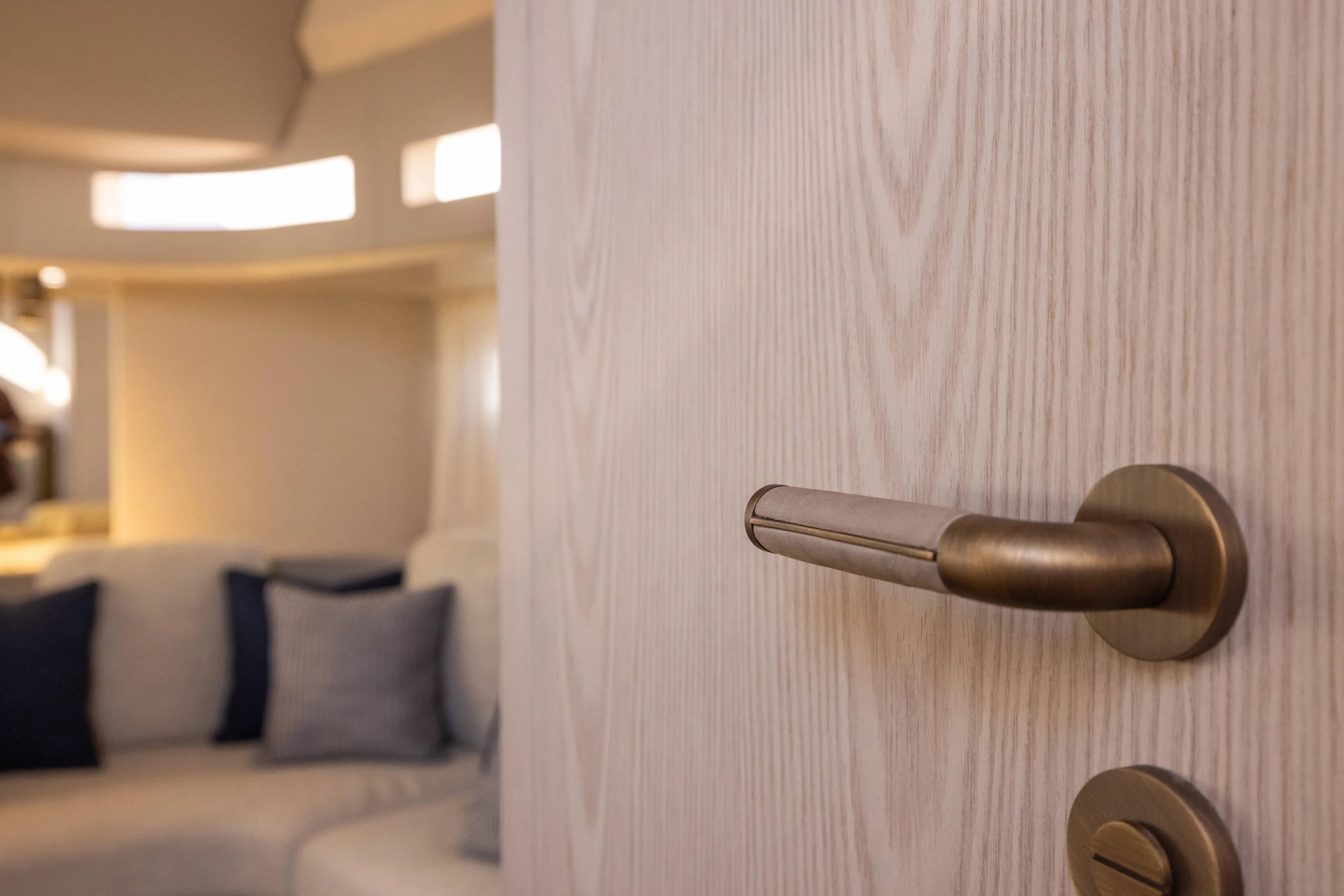  Yacht Photos Pics Interior of 2026 Invictus TT460 yacht, featuring a modern door handle and cozy seating area.