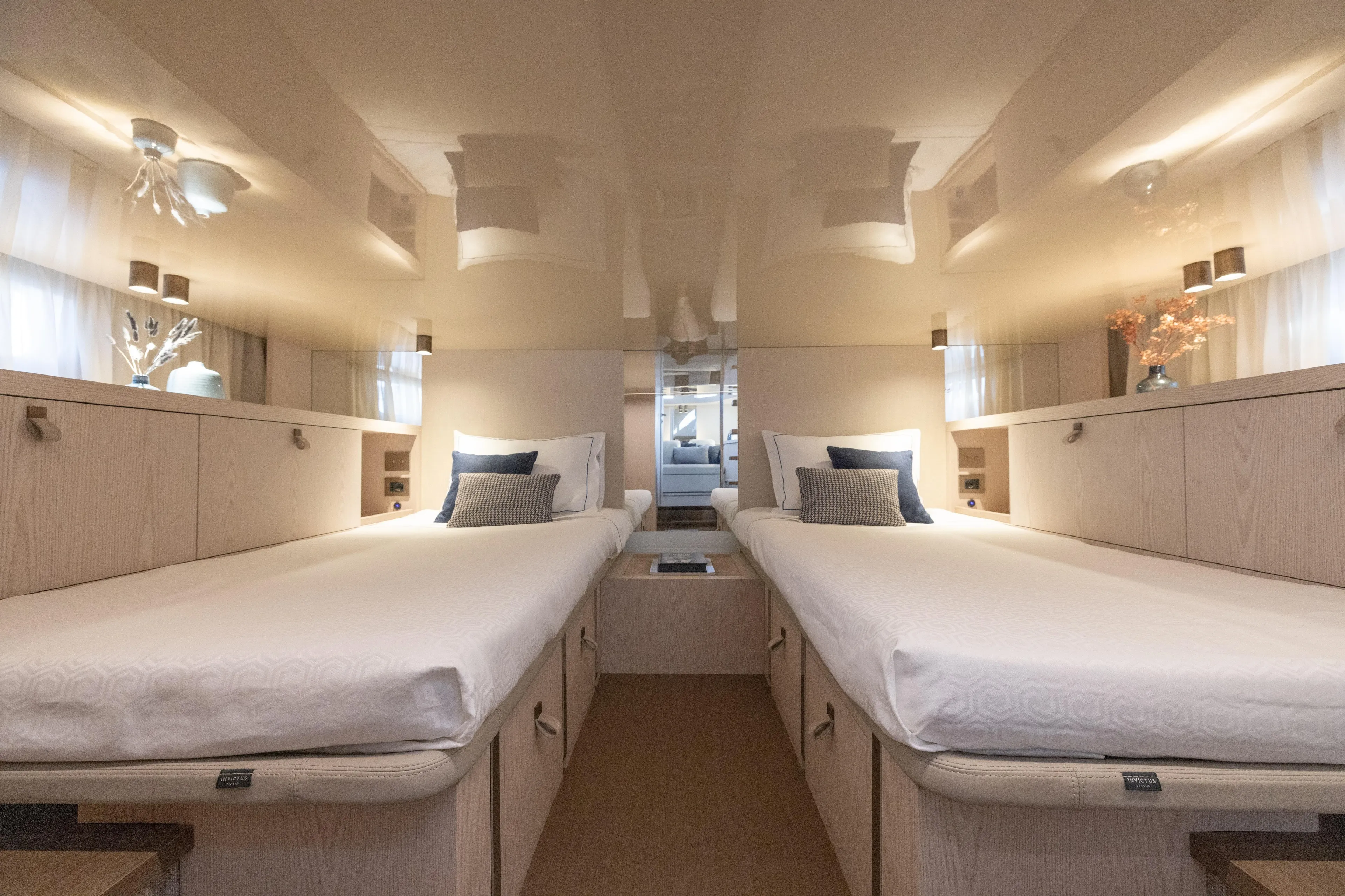  Yacht Photos Pics Luxurious twin cabin interior of 2026 Invictus TT460 yacht, featuring elegant decor and bedding.