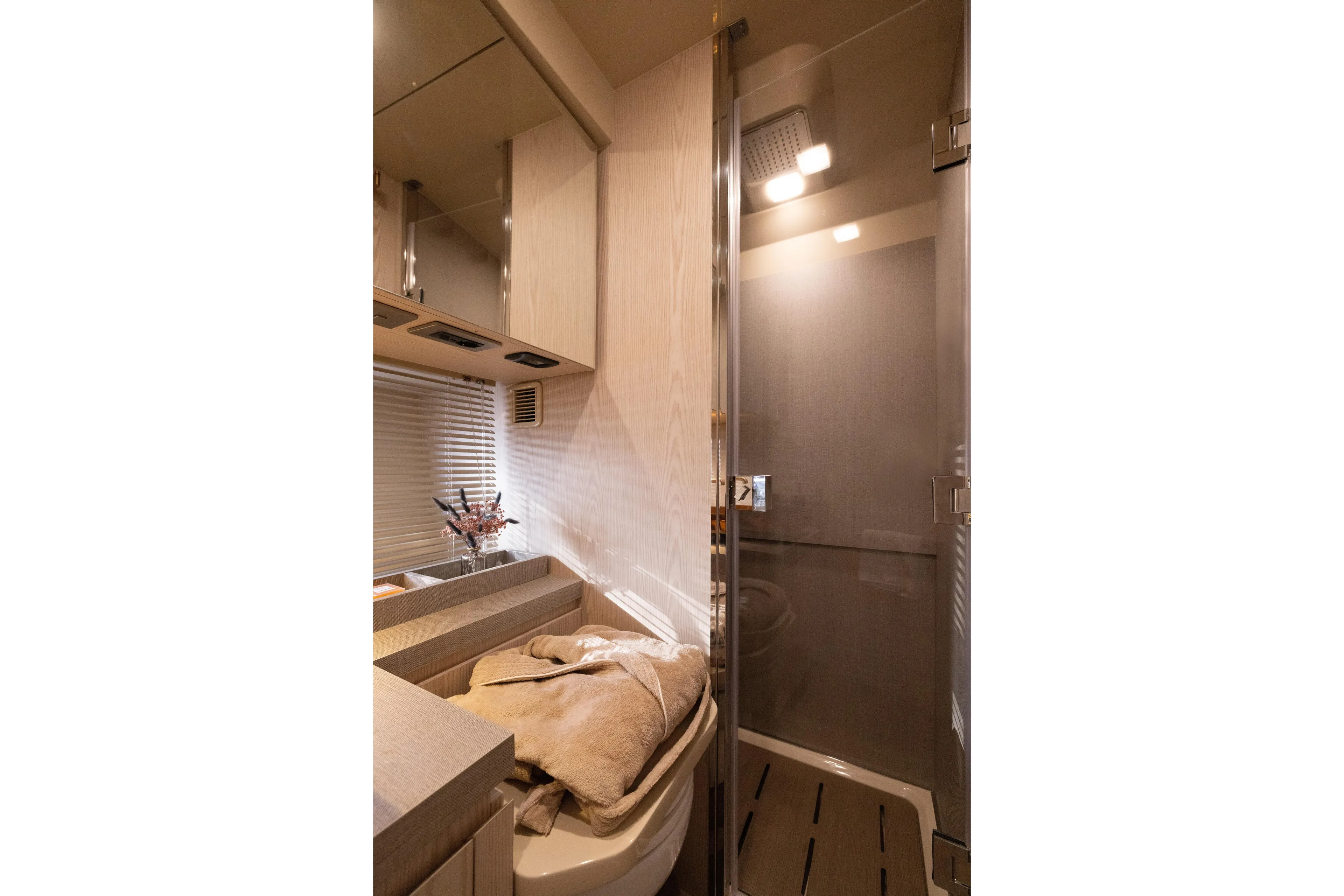  Yacht Photos Pics Luxurious bathroom interior of 2026 Invictus TT460 yacht with modern shower and elegant decor.