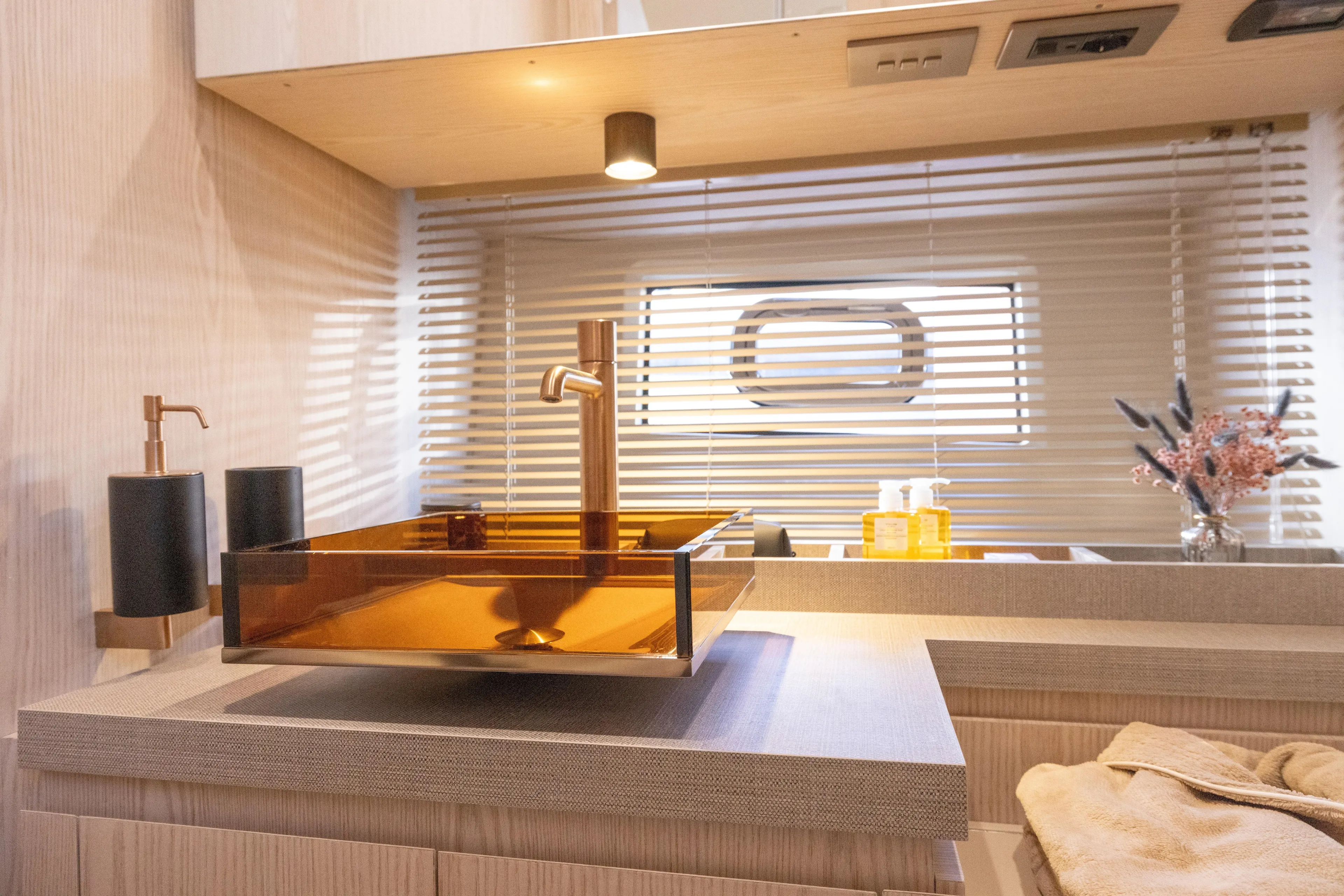  Yacht Photos Pics Luxurious bathroom interior of 2026 Invictus TT460 yacht with modern sink and decor.