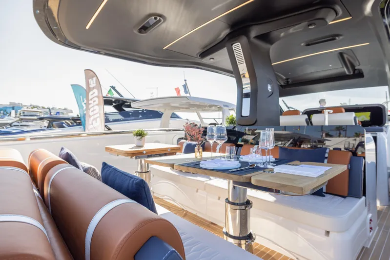  Yacht Photos Pics Luxurious 2026 Invictus TT460 yacht interior with elegant dining setup and modern design.