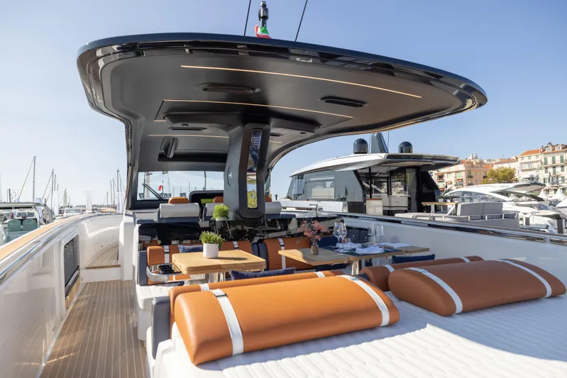  Yacht Photos Pics Luxurious 2026 Invictus TT460 yacht with elegant deck and seating area in marina setting.