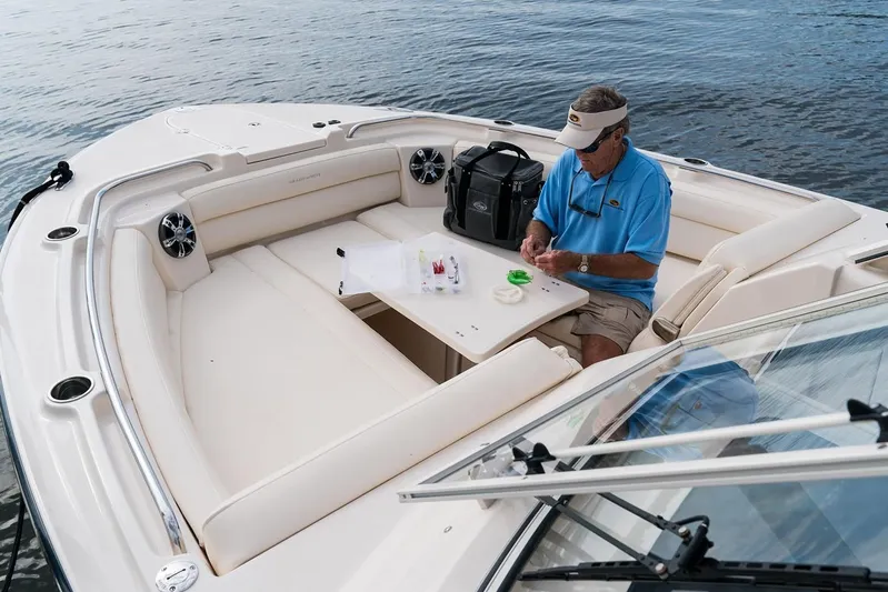  Yacht Photos Pics Man on 2018 Grady-White Freedom 325 boat, preparing fishing gear.