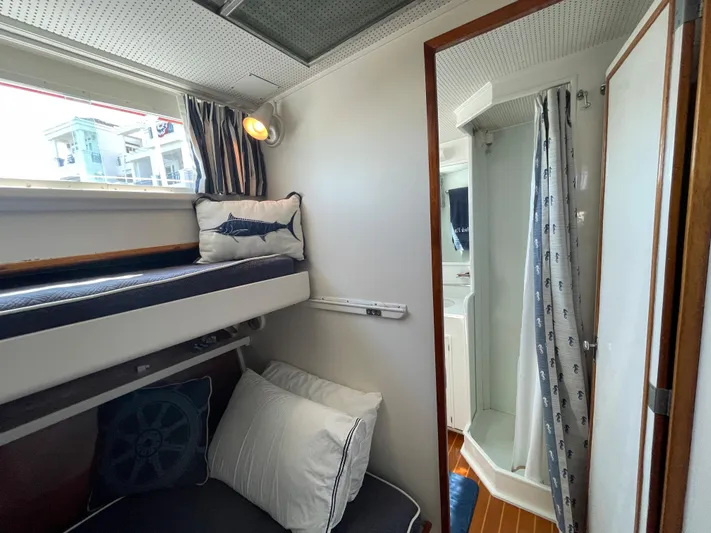 Huck Fin Yacht Photos Pics 1966 Huckins Sportsman cabin with bunk beds and compact shower area.