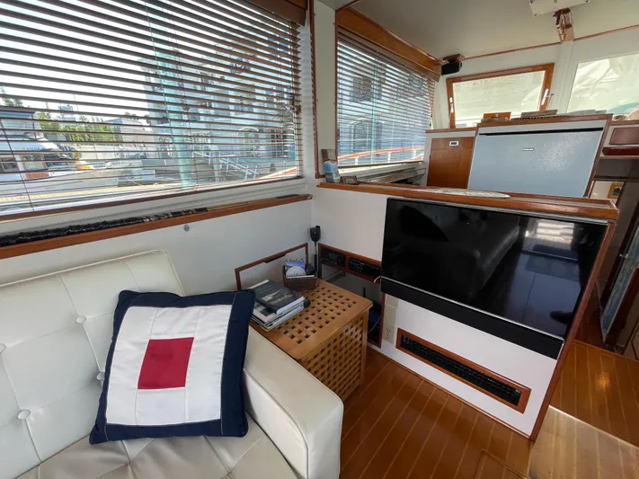 Huck Fin Yacht Photos Pics Interior of a 1966 Huckins Sportsman yacht with modern furnishings and nautical decor.