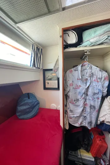 Huck Fin Yacht Photos Pics 1966 Huckins Sportsman cabin with bed, closet, and nautical decor.