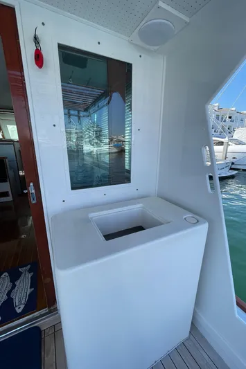 Huck Fin Yacht Photos Pics 1966 Huckins Sportsman boat interior with window and storage compartment.