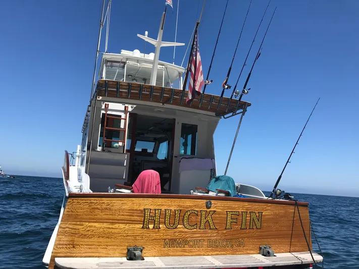 Huck Fin Yacht Photos Pics 1966 Huckins Sportsman boat named "Huck Fin" on open water, Newport Beach, CA.