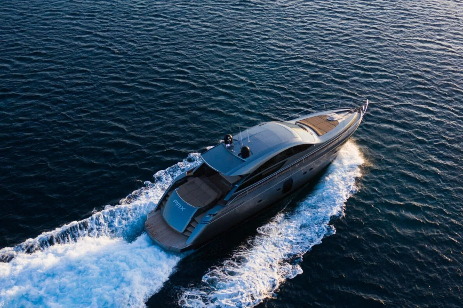 2008 Pershing 64' yacht cruising on open water, aerial view.