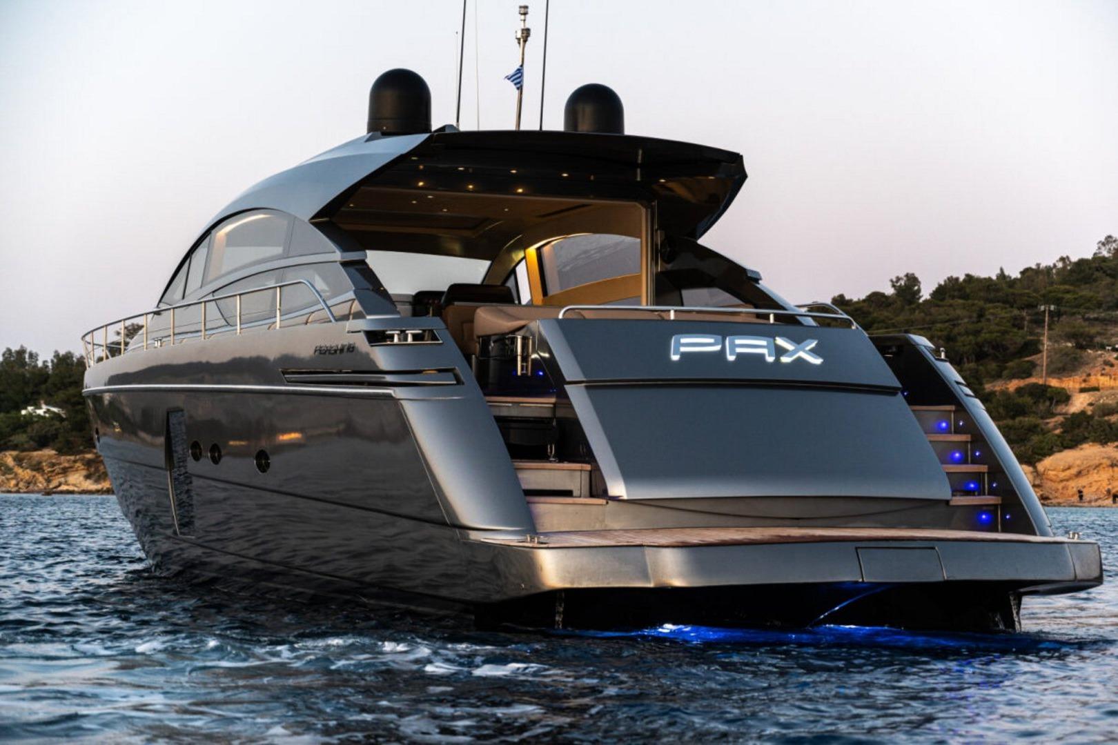 Luxurious 2008 Pershing 64' yacht on serene waters at sunset, featuring sleek design and illuminated name.