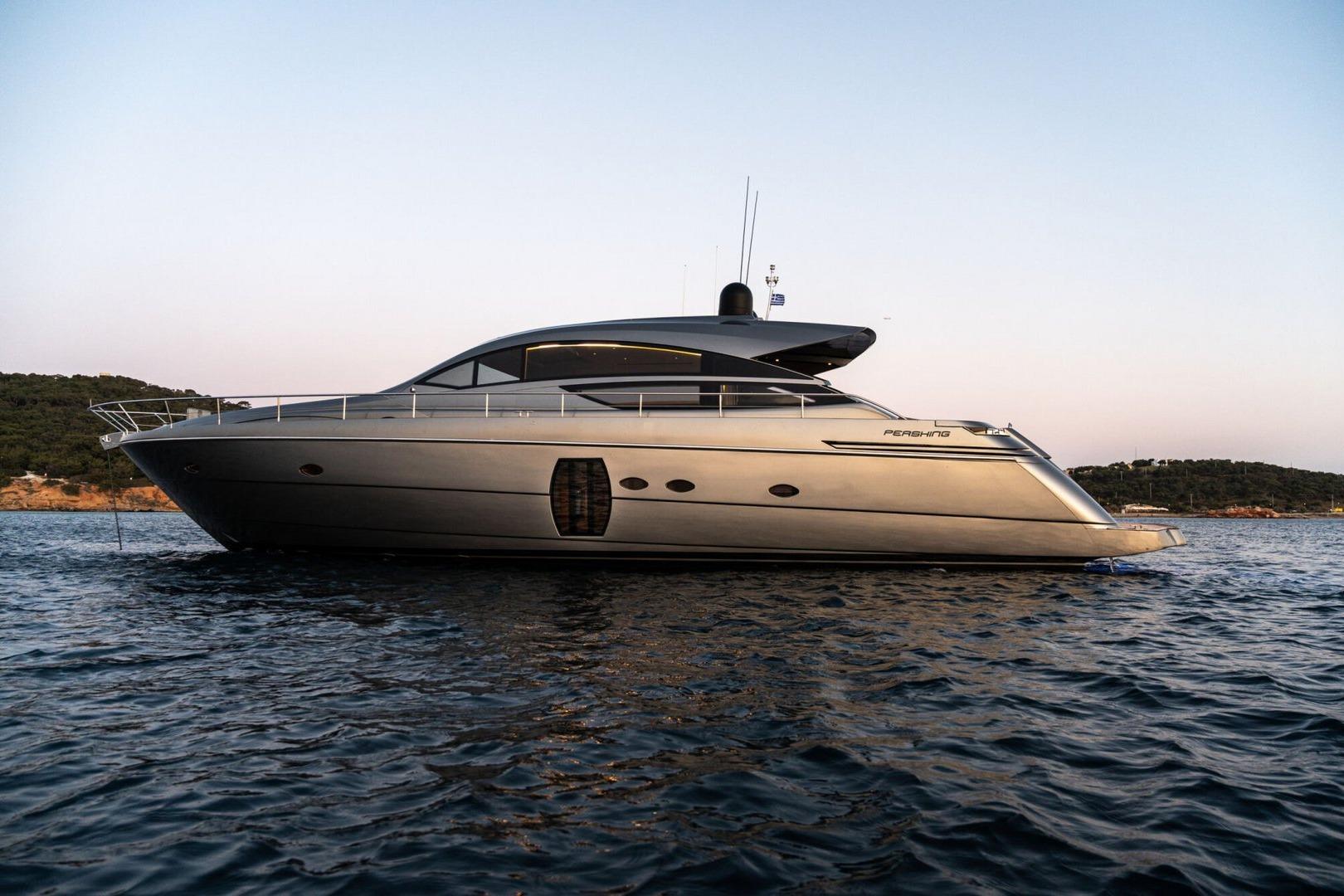 2008 Pershing 64' yacht on calm water at sunset, sleek design, side view.