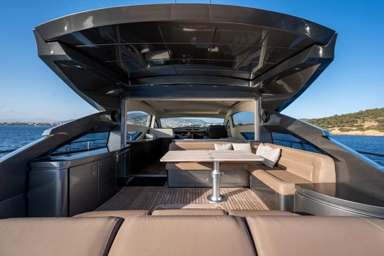 Luxurious 2008 Pershing 64' yacht with spacious outdoor seating and ocean view.