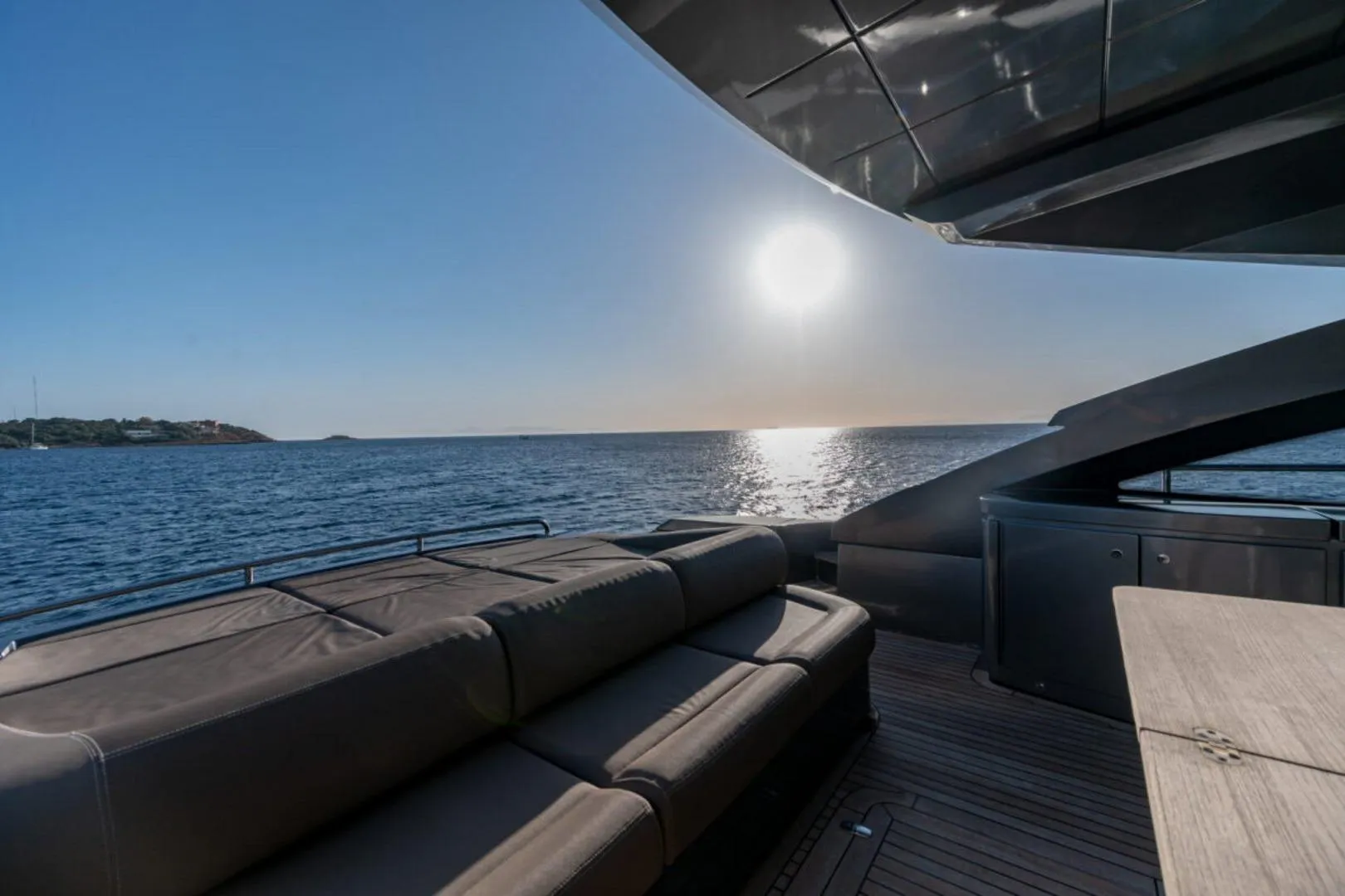 Luxurious 2008 Pershing 64' yacht deck with ocean view at sunset.