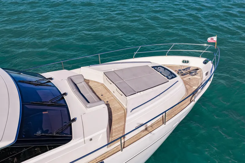 Fortunato Yacht Photos Pics Luxurious 2014 Princess Y72 yacht on serene blue waters, showcasing elegant deck design.