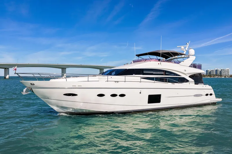 Fortunato Yacht Photos Pics Luxurious 2014 Princess Y72 yacht cruising on clear blue waters under a sunny sky.