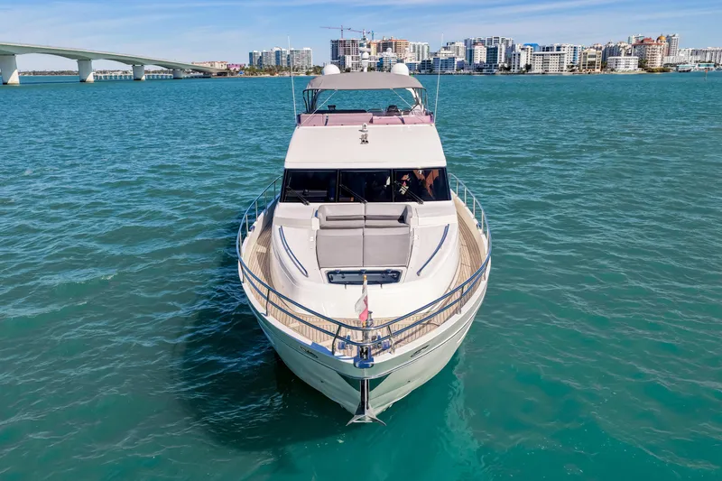 Fortunato Yacht Photos Pics 2014 Princess Y72 yacht on blue water with cityscape and bridge in background.