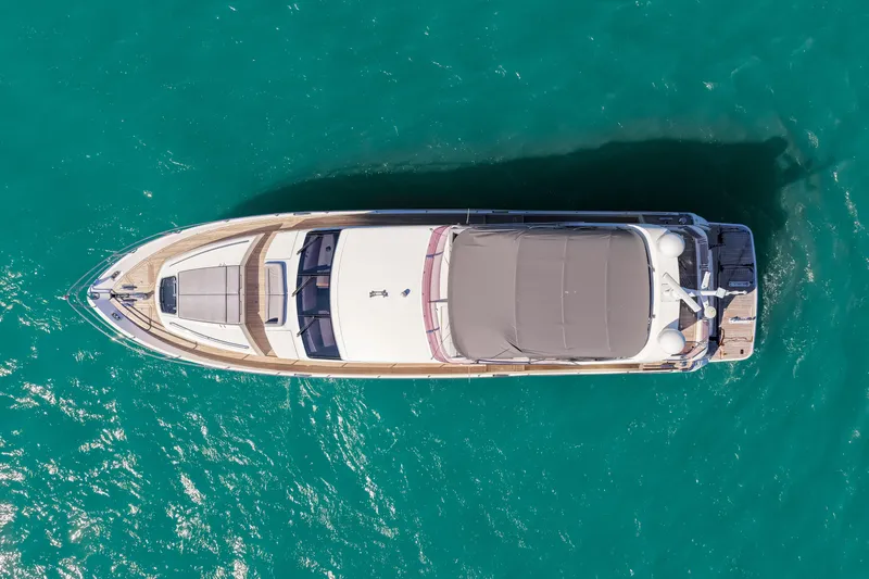 Fortunato Yacht Photos Pics Aerial view of 2014 Princess Y72 yacht on turquoise water.