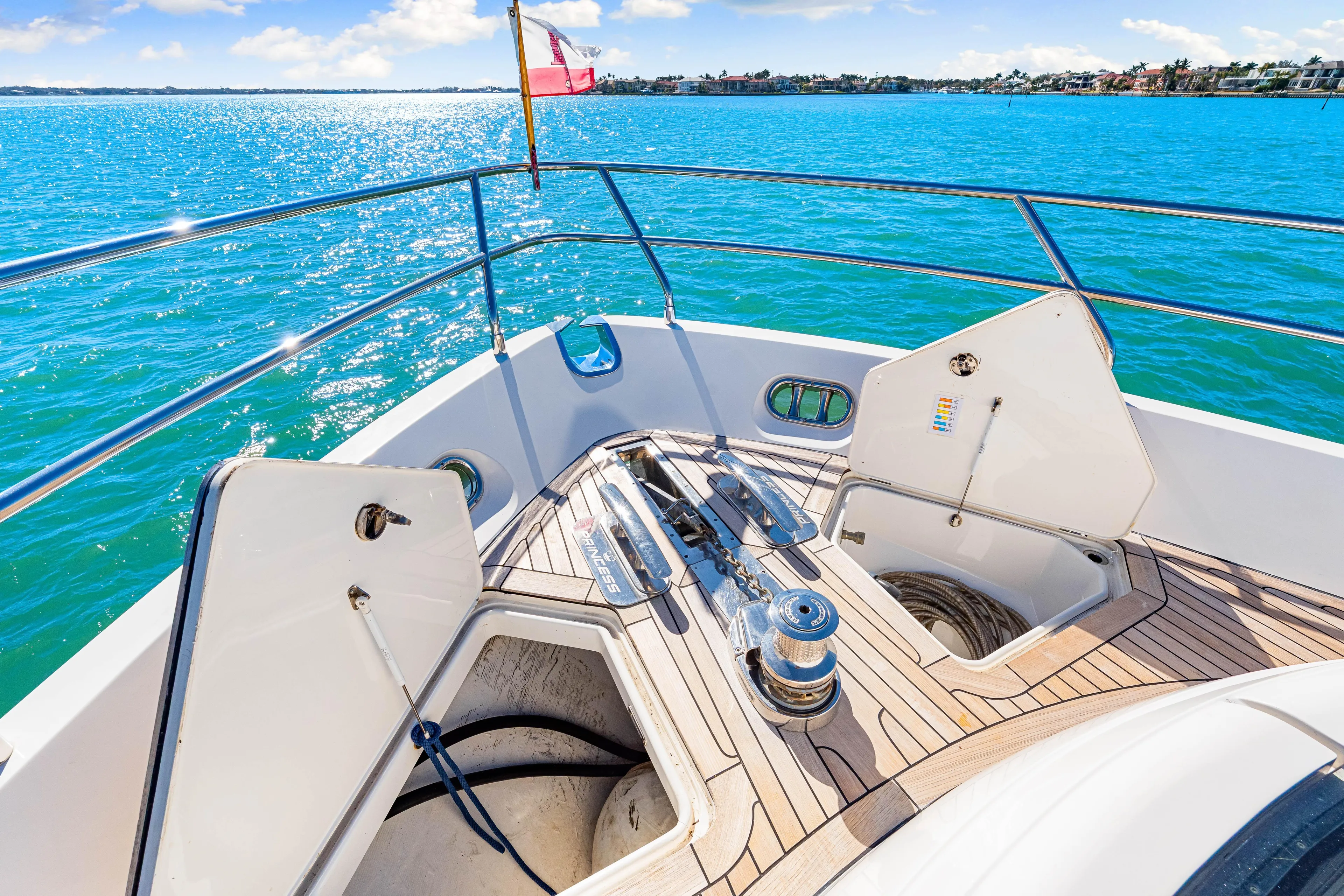 Fortunato Yacht Photos Pics Deck of 2014 Princess Y72 yacht with open storage compartments, overlooking sparkling blue water.