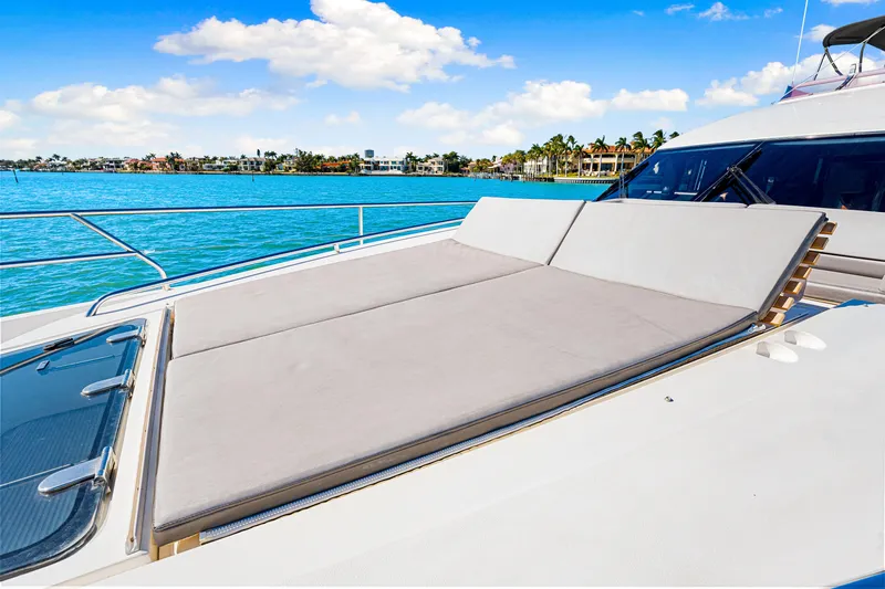Fortunato Yacht Photos Pics Luxurious 2014 Princess Y72 yacht with sunbathing deck, overlooking serene blue waters.