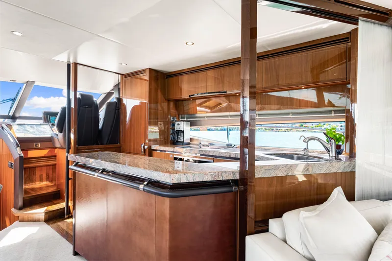 Fortunato Yacht Photos Pics Luxurious interior of 2014 Princess Y72 yacht with modern kitchen and elegant wood finishes.