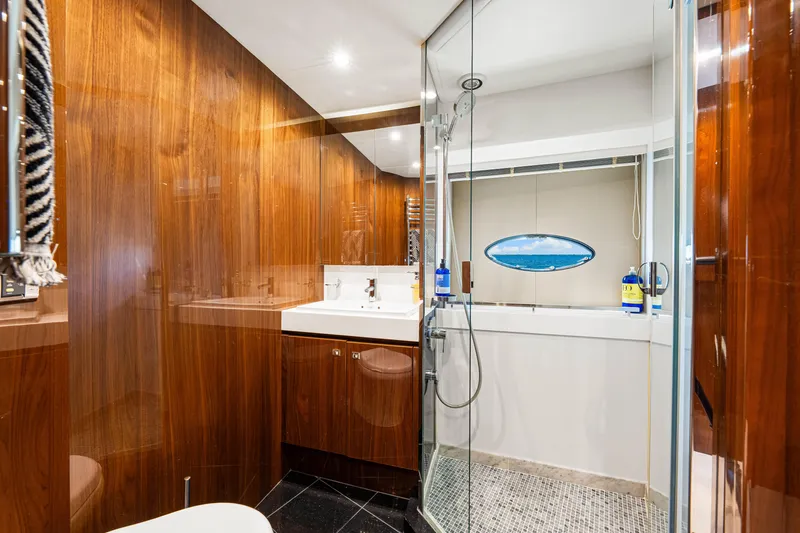 Fortunato Yacht Photos Pics Luxurious bathroom in 2014 Princess Y72 yacht with wood paneling and glass shower.