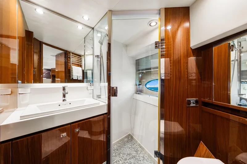 Fortunato Yacht Photos Pics Luxurious bathroom on 2014 Princess Y72 yacht with wood accents and modern fixtures.