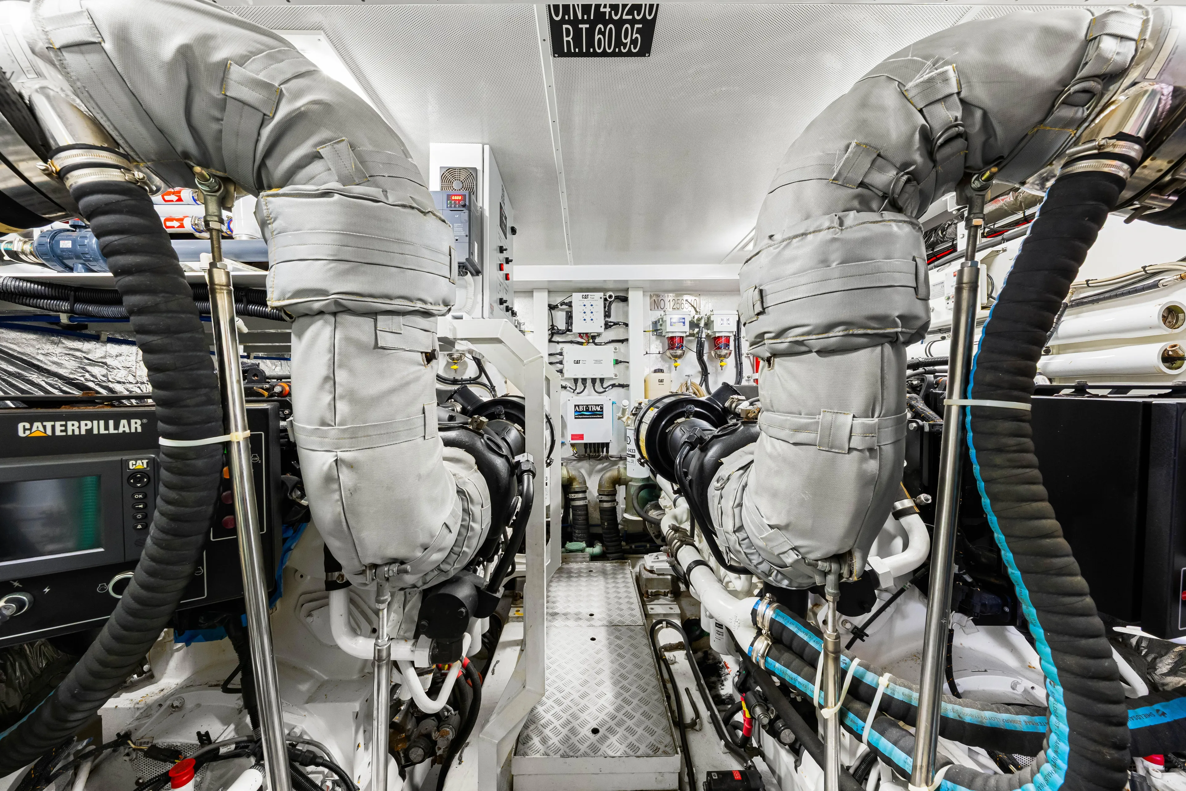 Fortunato Yacht Photos Pics Engine room of 2014 Princess Y72 yacht with Caterpillar machinery and insulated exhaust pipes.