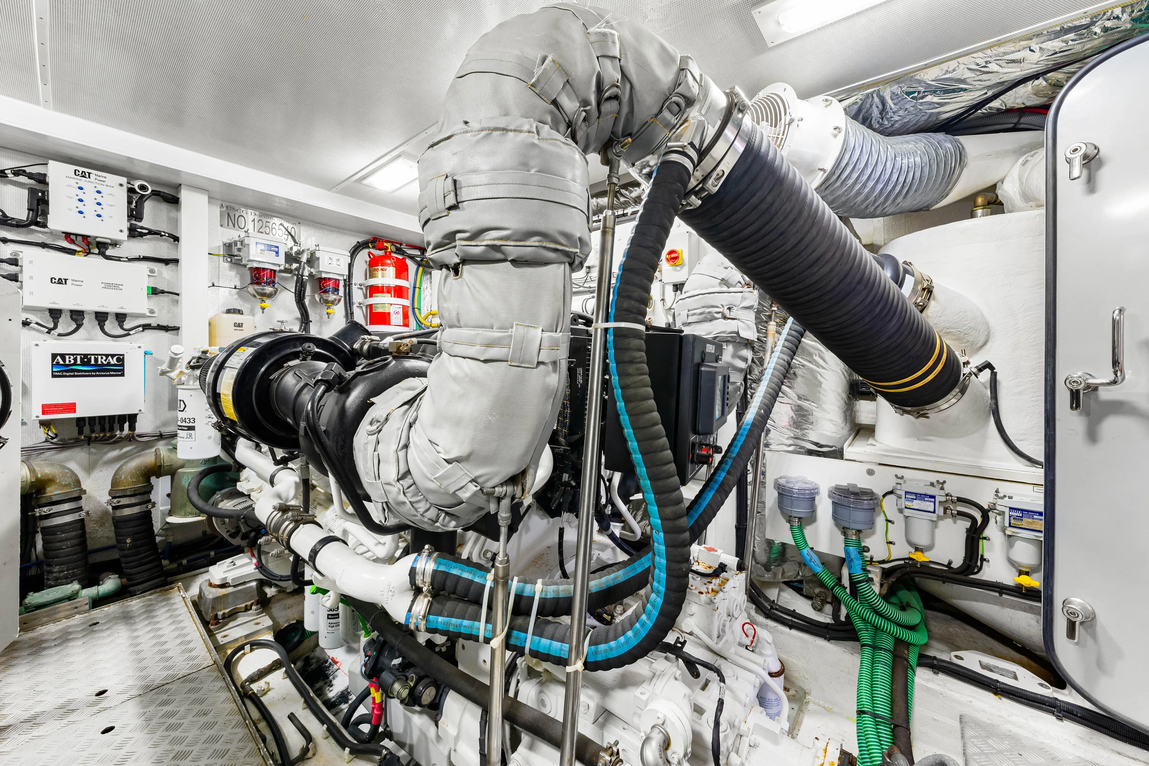 Fortunato Yacht Photos Pics Engine room of a 2014 Princess Y72 yacht, showcasing complex machinery and piping systems.