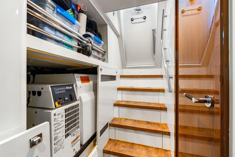 Fortunato Yacht Photos Pics Engine room of 2014 Princess Y72 yacht with Cummins Onan generator and storage shelves.