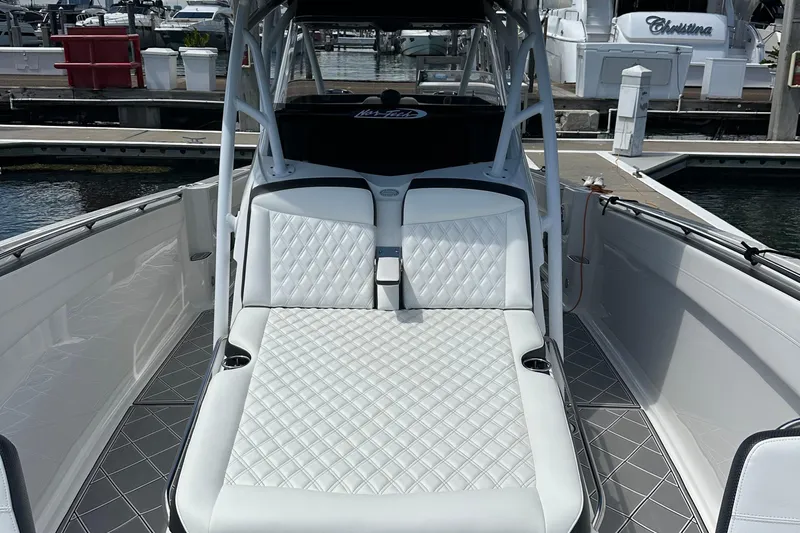  Yacht Photos Pics 2019 Nor-Tech 390 Sport Center Console with luxurious white seating at a marina.