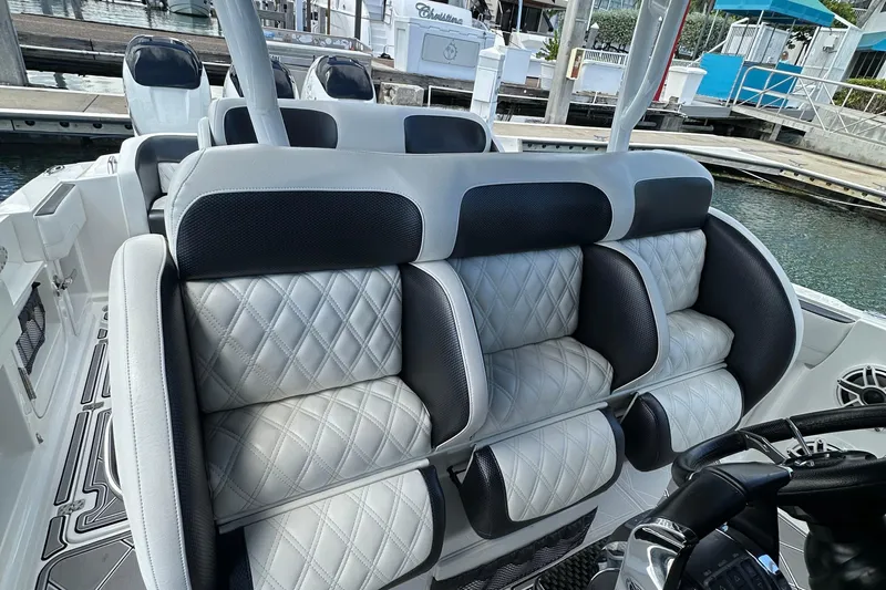  Yacht Photos Pics Luxurious seating on a 2019 Nor-Tech 390 Sport Center Console boat, docked at a marina.