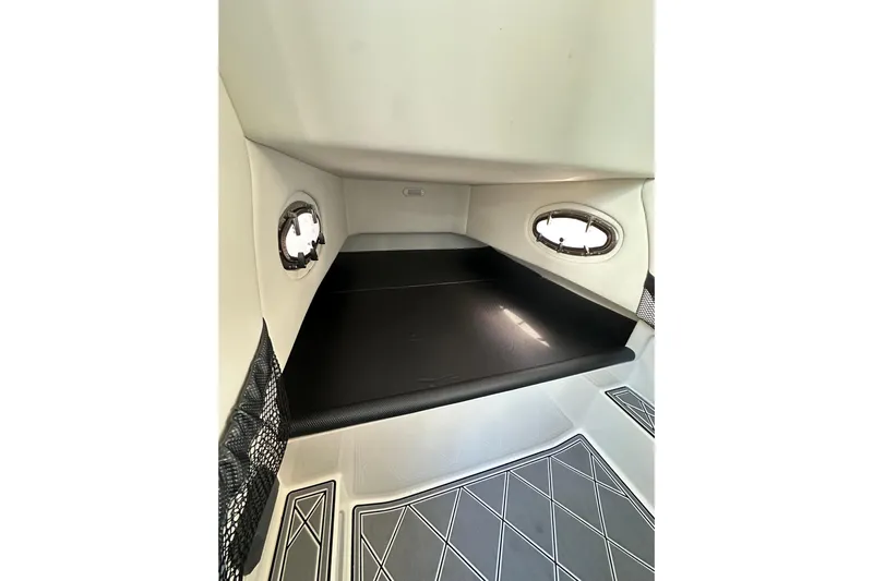  Yacht Photos Pics 2019 Nor-Tech 390 Sport Center Console cabin interior with portholes and cushioned seating.