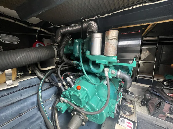  Yacht Photos Pics Engine room of 2004 Cranchi Atlantique 48 yacht, featuring a green marine engine.