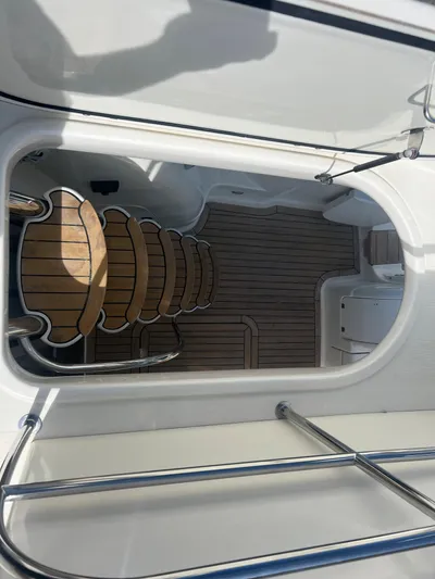  Yacht Photos Pics Cranchi Atlantique 48 yacht, 2004 model, featuring teak deck and elegant interior staircase.