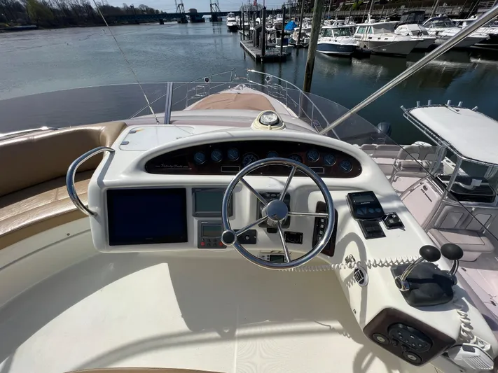  Yacht Photos Pics 2004 Cranchi Atlantique 48 yacht helm with steering wheel and navigation controls.