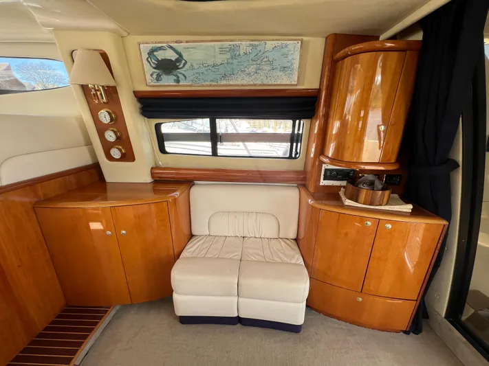  Yacht Photos Pics Luxurious interior of 2004 Cranchi Atlantique 48 yacht with elegant wood cabinetry and seating.
