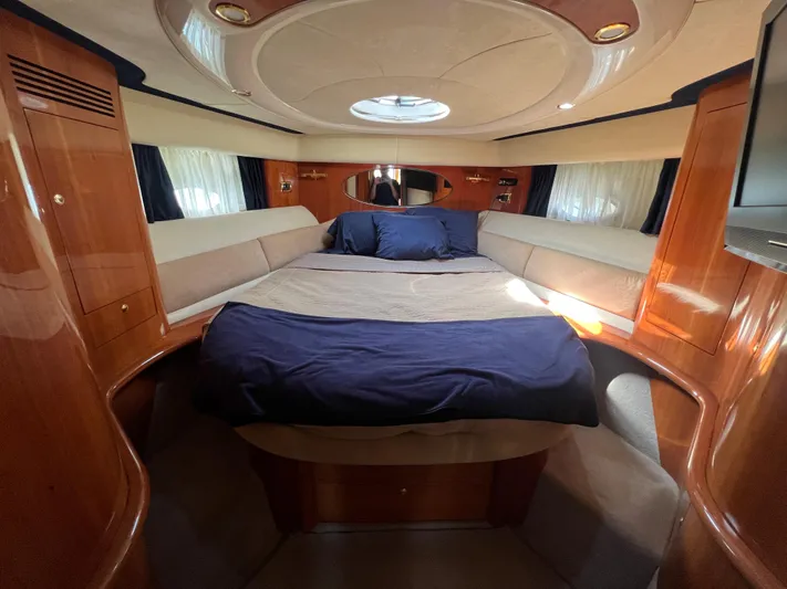  Yacht Photos Pics Luxurious cabin interior of 2004 Cranchi Atlantique 48 yacht with elegant wood finish.
