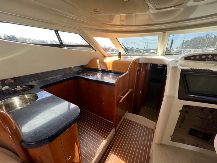  Yacht Photos Pics Interior of 2004 Cranchi Atlantique 48 yacht with sleek kitchen and modern design.