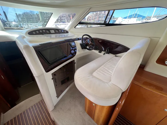  Yacht Photos Pics Interior helm of 2004 Cranchi Atlantique 48 yacht with modern controls and plush seating.