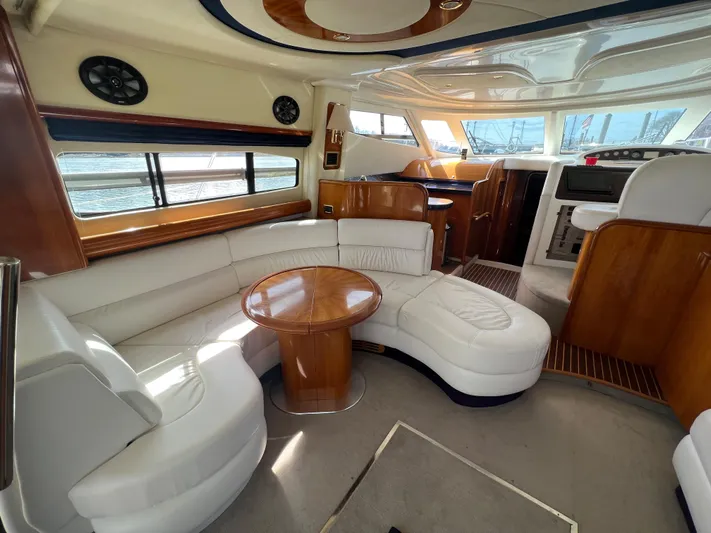  Yacht Photos Pics Luxurious 2004 Cranchi Atlantique 48 yacht interior with elegant seating and wooden accents.