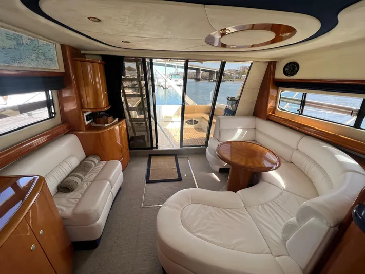  Yacht Photos Pics Luxurious interior of 2004 Cranchi Atlantique 48 yacht with white leather seating and wooden accents.
