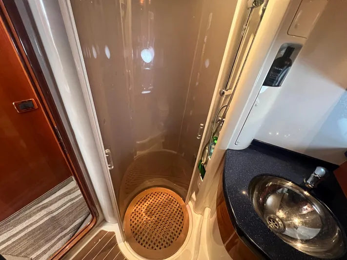  Yacht Photos Pics Shower area in 2004 Cranchi Atlantique 48 yacht with modern sink and wooden flooring.