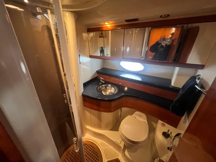  Yacht Photos Pics Luxurious bathroom in 2004 Cranchi Atlantique 48 yacht with modern fixtures and elegant design.