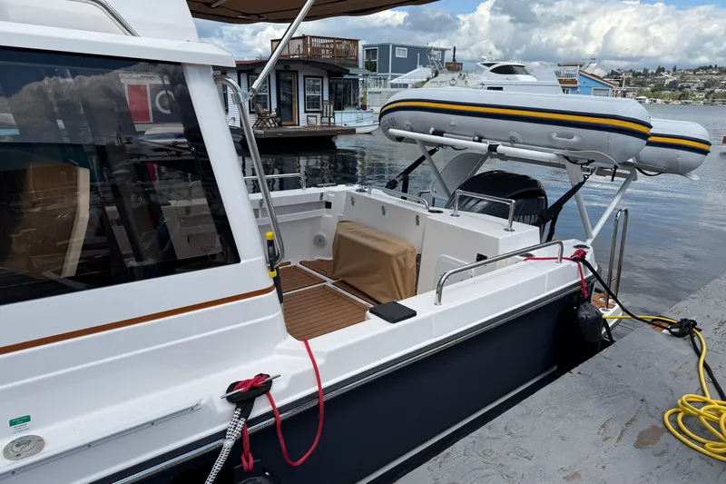  Yacht Photos Pics 2024 Ranger Tugs R-25 docked with inflatable boat on davit system.