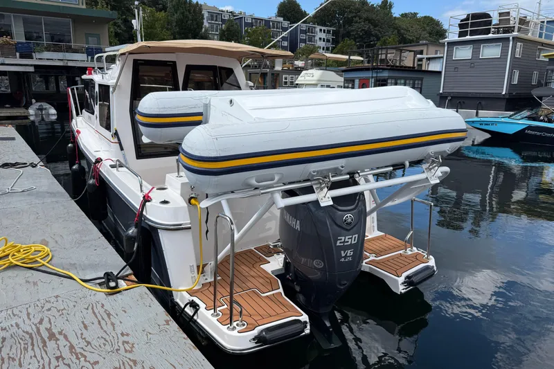  Yacht Photos Pics 2024 Ranger Tugs R-25 with Yamaha 250 V6 engine docked, featuring inflatable boat on stern.