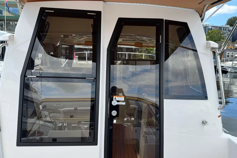  Yacht Photos Pics 2024 Ranger Tugs R-25 boat cabin entrance with glass doors and windows.