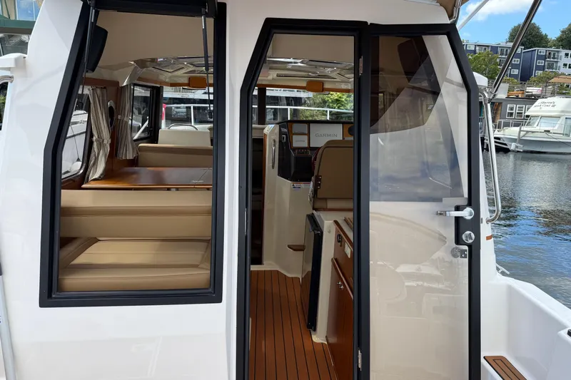  Yacht Photos Pics 2024 Ranger Tugs R-25 interior view with seating and navigation area.