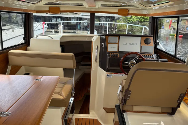  Yacht Photos Pics Interior of 2024 Ranger Tugs R-25 boat with Garmin navigation system and seating.