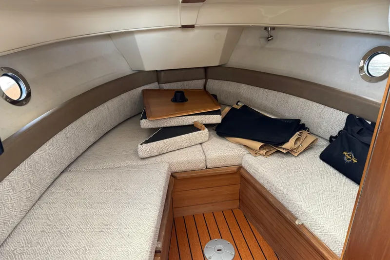  Yacht Photos Pics 2024 Ranger Tugs R-25 cabin interior with cozy seating and wooden accents.